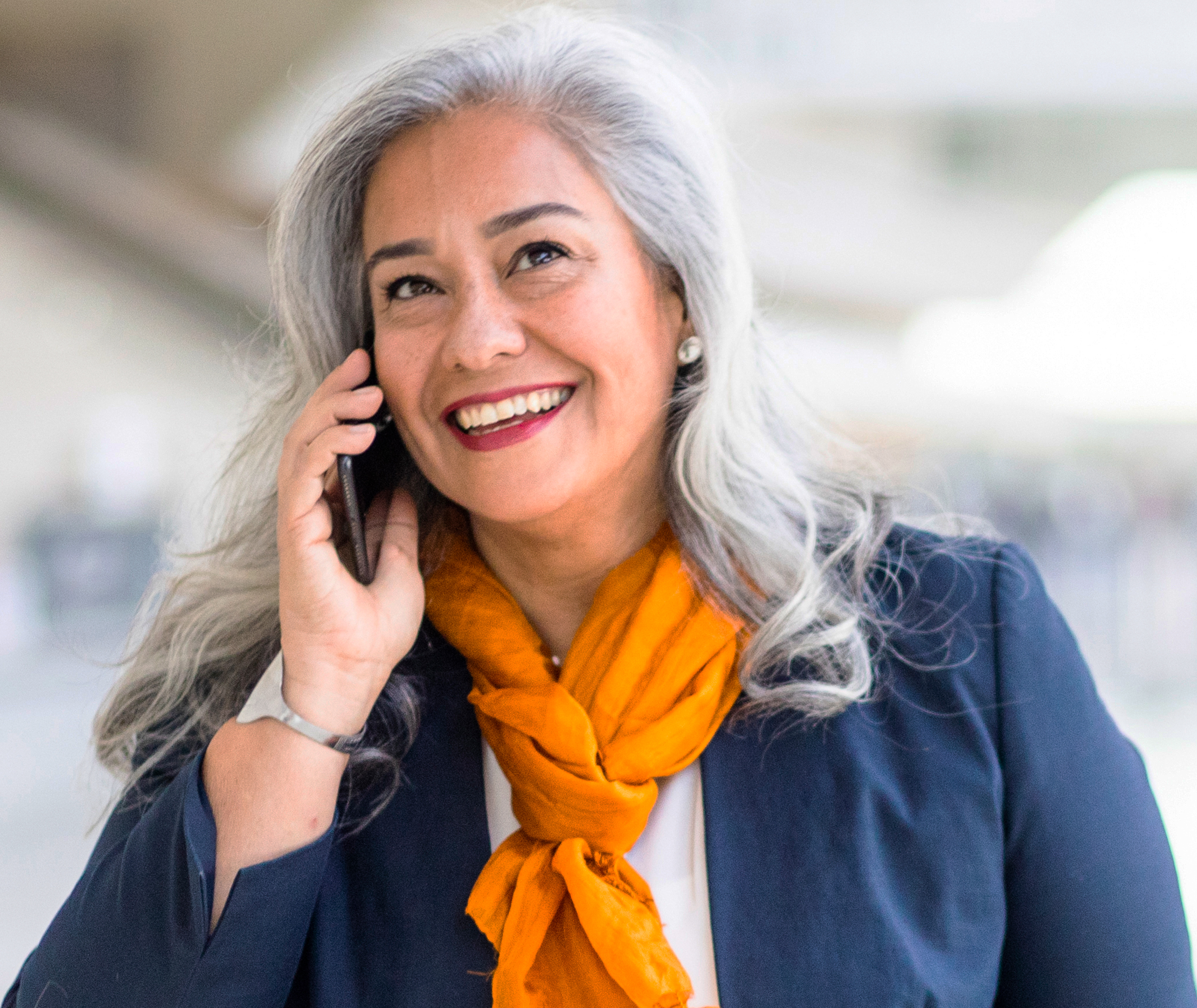 Smiling woman talking on a mobile phone